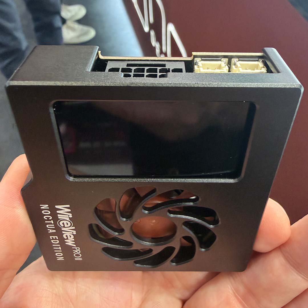 A Thermal Grizzly Wire View Pro II Noctua Edition held between a finger and thumb.