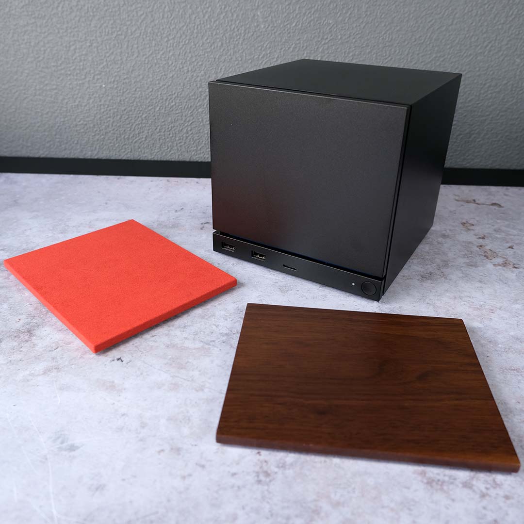 The Steam Machine (back right), surrounded by optional faceplates.