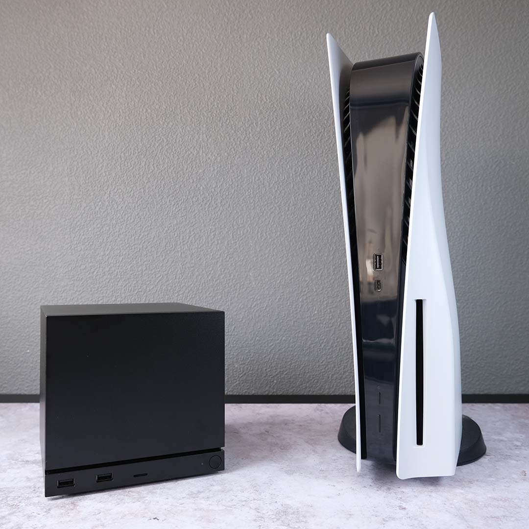 A Steam Machine (left) next to a PlayStation 5 (right).