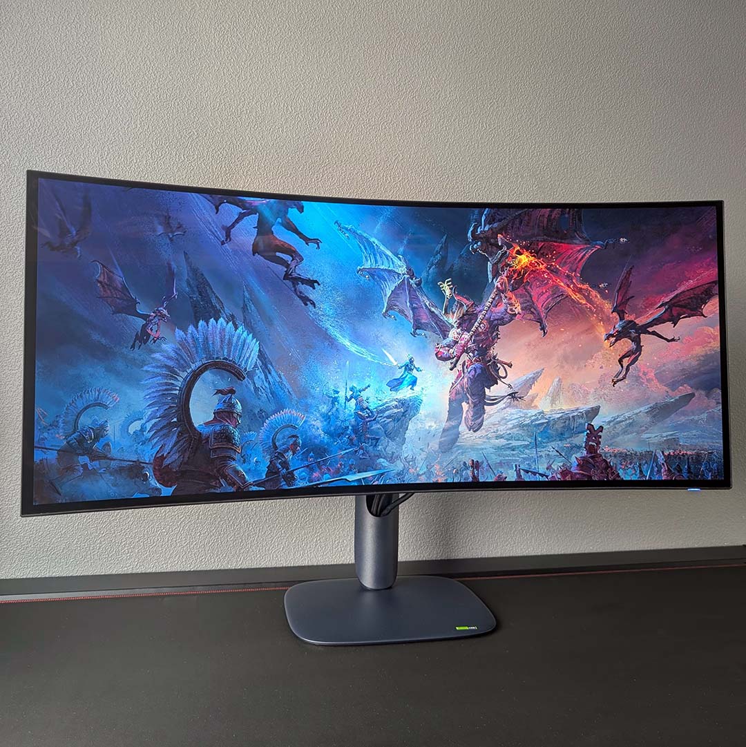 The AW3926QW displaying Total War: Warhammer III artwork.