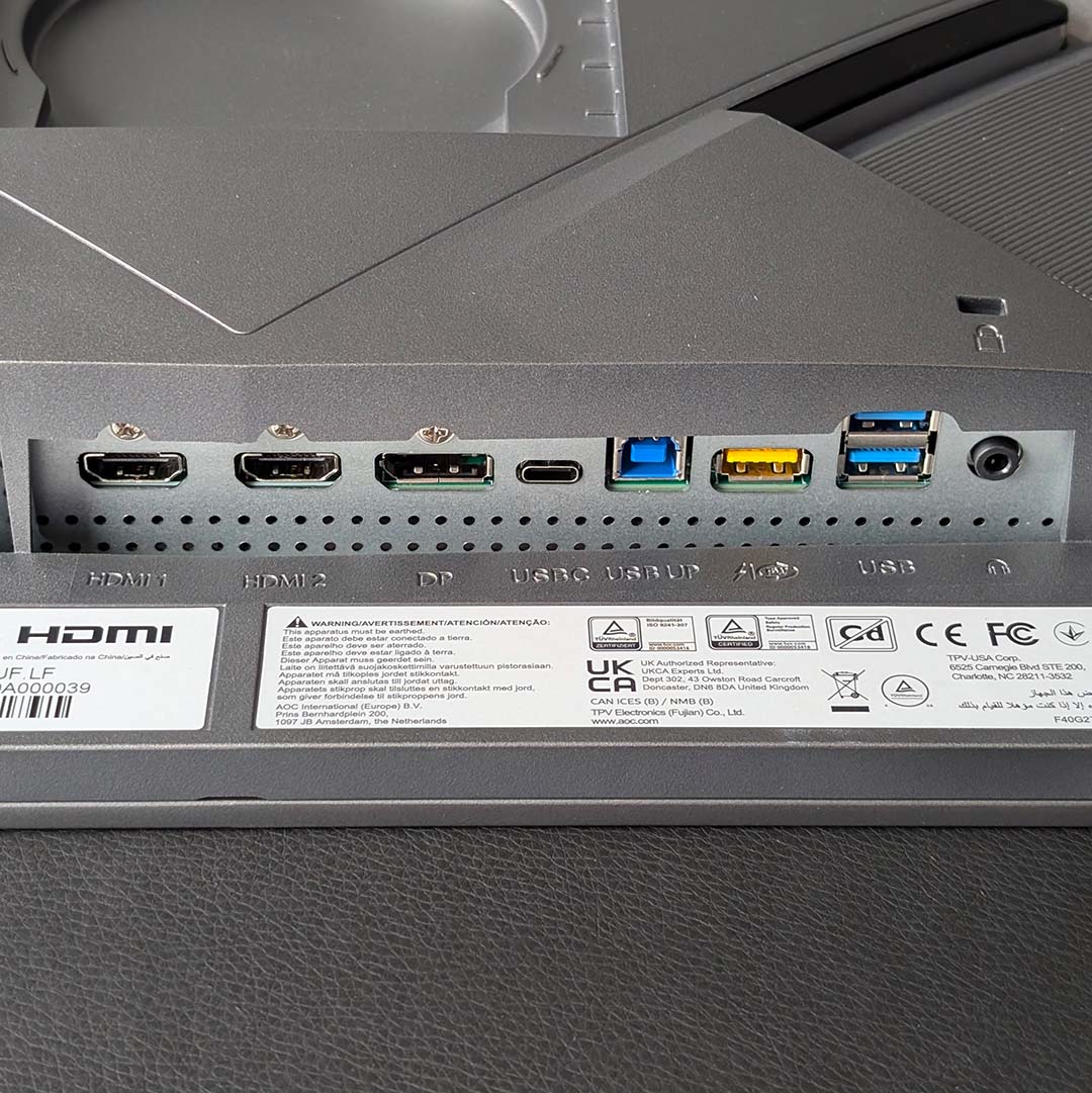 Display outputs and USB ports underneath the AOC Agon Pro AGP277QKDC's chassis.
