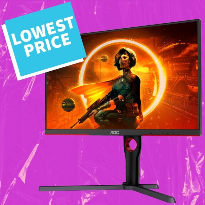 An AOC Q27G3XMNBK monitor, against a purple backdrop, with a blue sign that reads 'lowest price' attached to it.