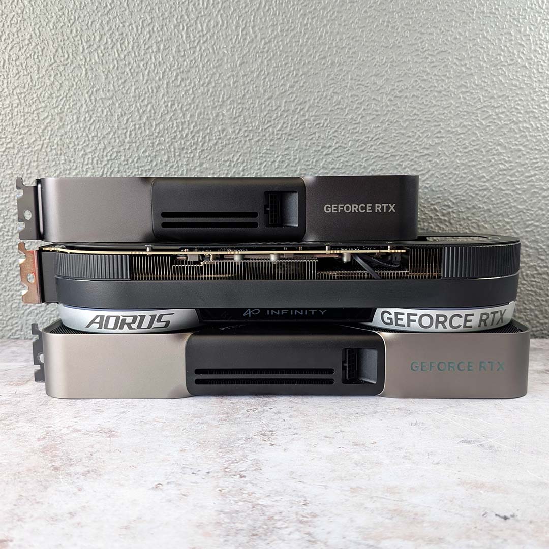 A GeForce RTX 5070 (top), Gigabyte Aorus GeForce RTX 5070 Infinity (middle), and GeForce RTX 5080 (bottom) lying horizontally.