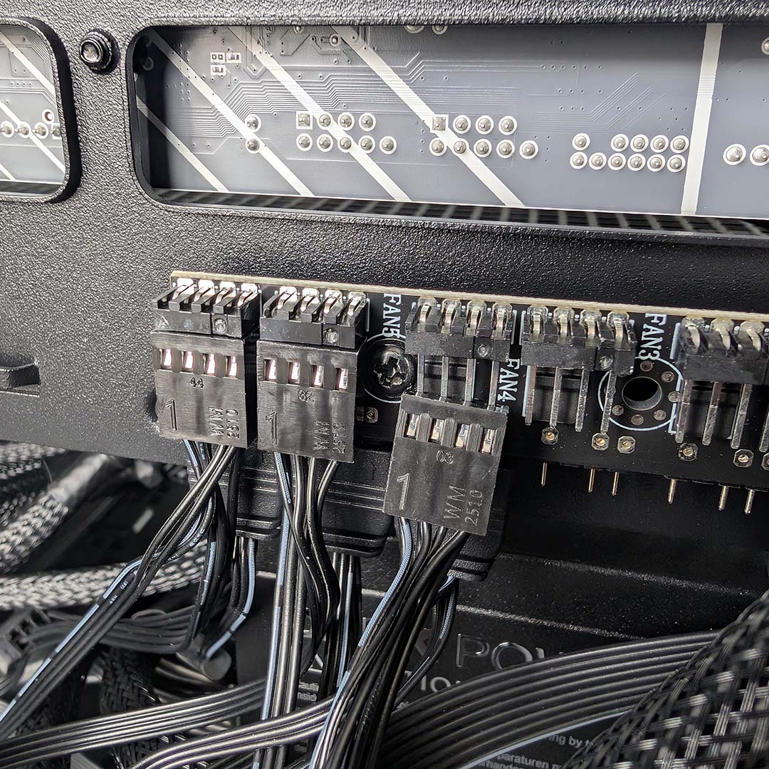 A close-up of the InWin Covalent's fan controller, where the third PWM cable isn't fitting due to a screw getting in the way.