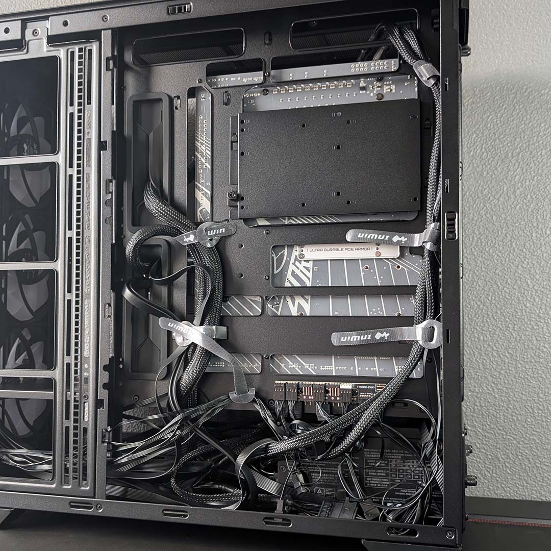 A bottom-up view of cables in the InWin Covalent, with Velcro tags.
