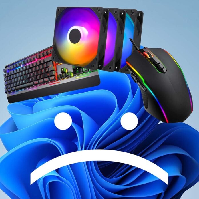 A Windows 11 'Bloom' wallpaper, with a sad face, with RGB peripherals on top of it.