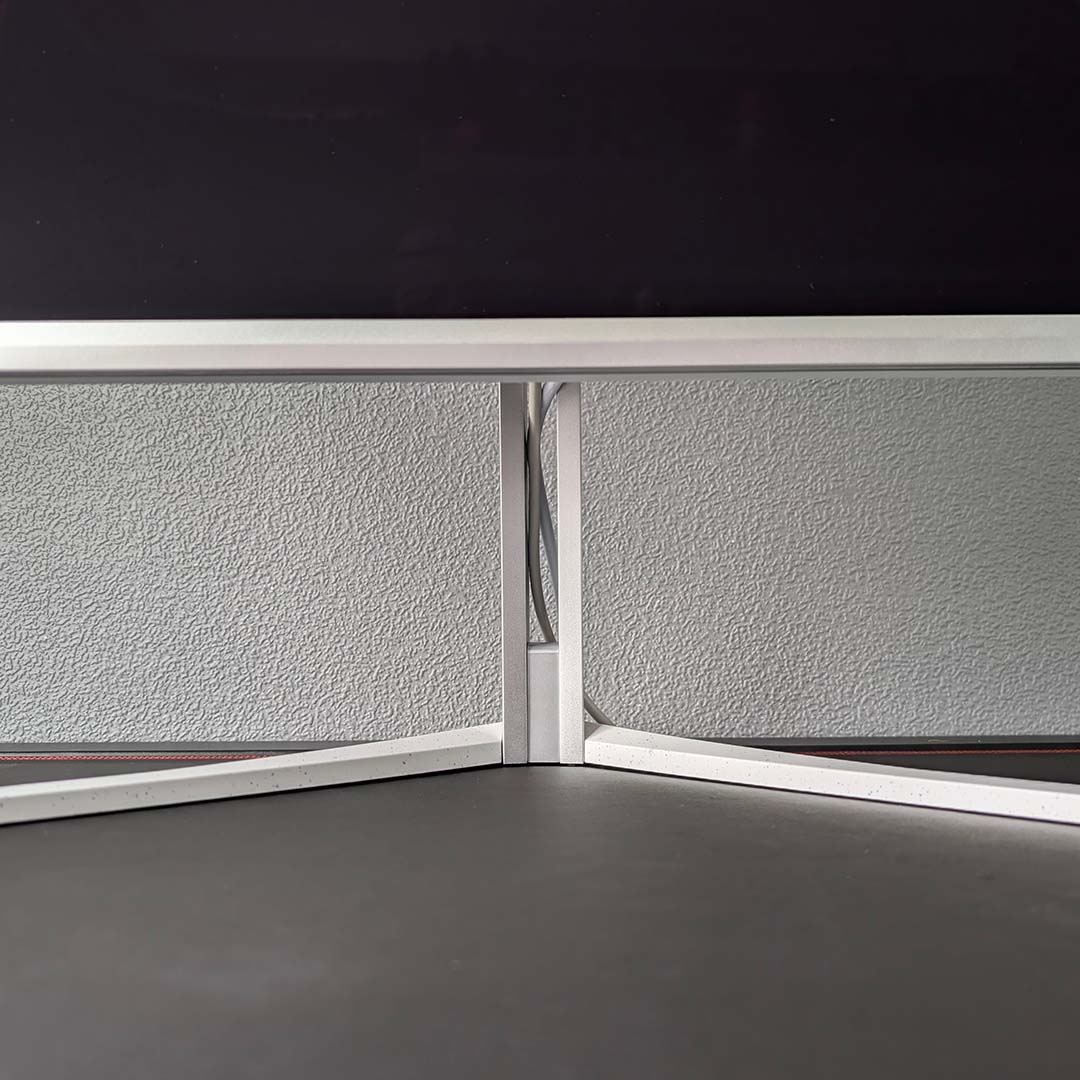 A close-up demonstrating how cable management works on the Evnia 32M2N8900P.