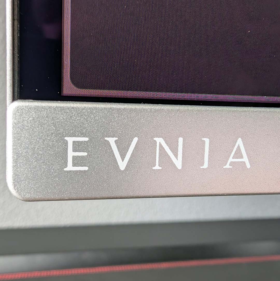 A close-up of the 'Evnia' logo on the Philips Evnia 32M2N8900P.