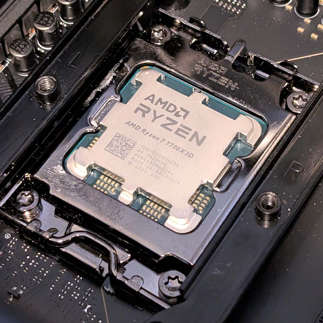 An AMD Ryzen 7 7700X3D in an AM5 motherboard socket.