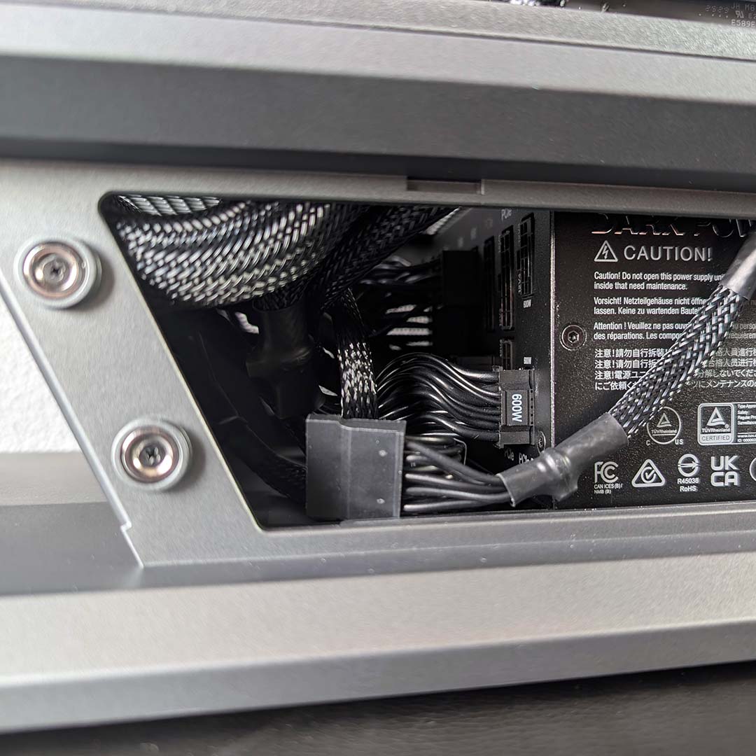 A close-up of cables in the MSI MPG Vixta 300R PZ's power supply chamber.