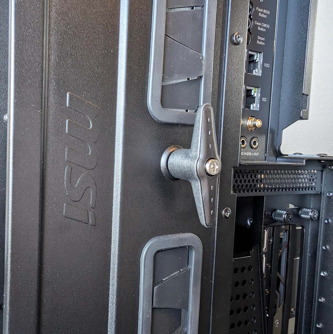 Handles attached to the MSI MEG Maestro 900R's detachable motherboard tray.