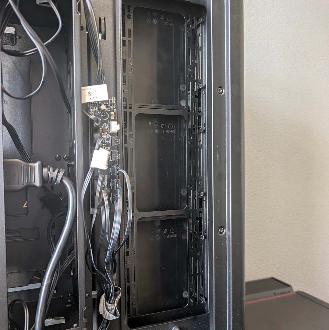 Fan brackets that double as storage brackets inside the MSI MEG Maestro 900R.