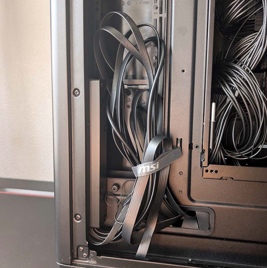 A close up for front I/O cables, bundled together in the MSI MEG Maestro 900R.