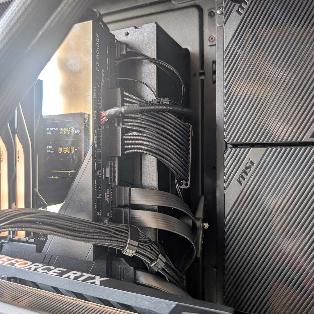 A close-up of motherboard cables running to a PCB in the MSI MEG Maestro 900R.