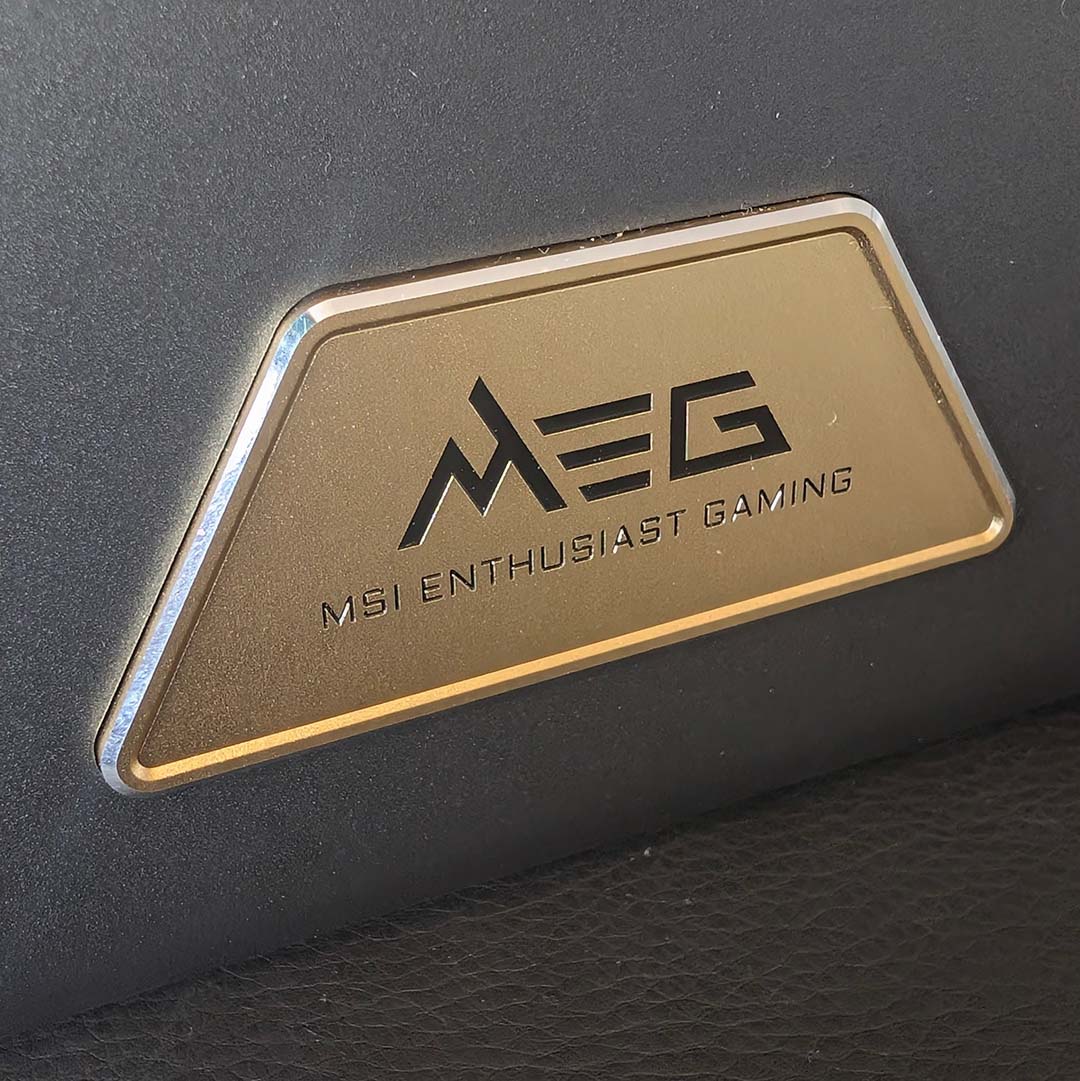A close-up of the MEG badge on the front of the MSI MEG Maestro 900R.