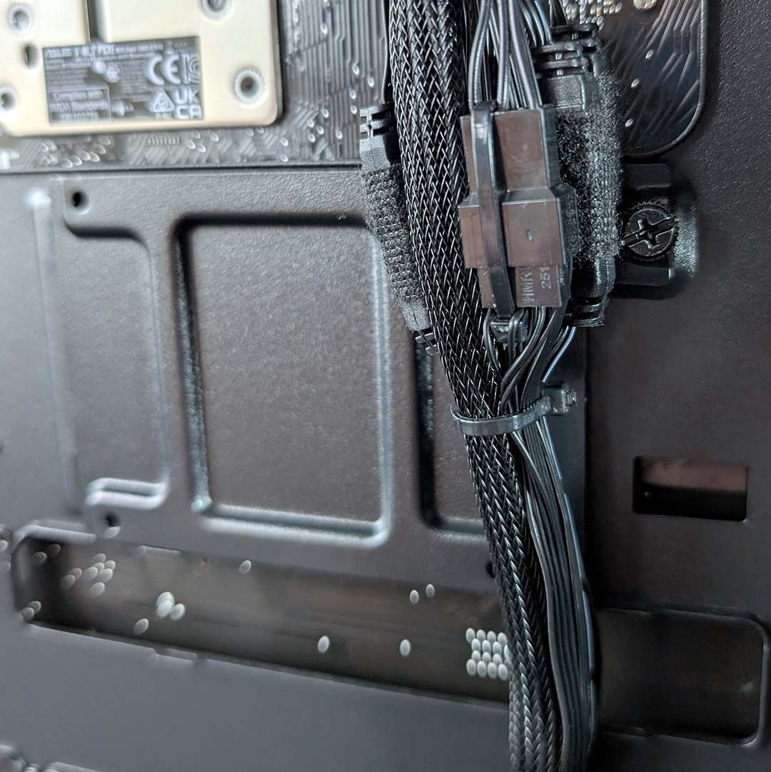 A close up of cables covering the 2.5 SSD mount on the PCSpecialist Noble Extreme.