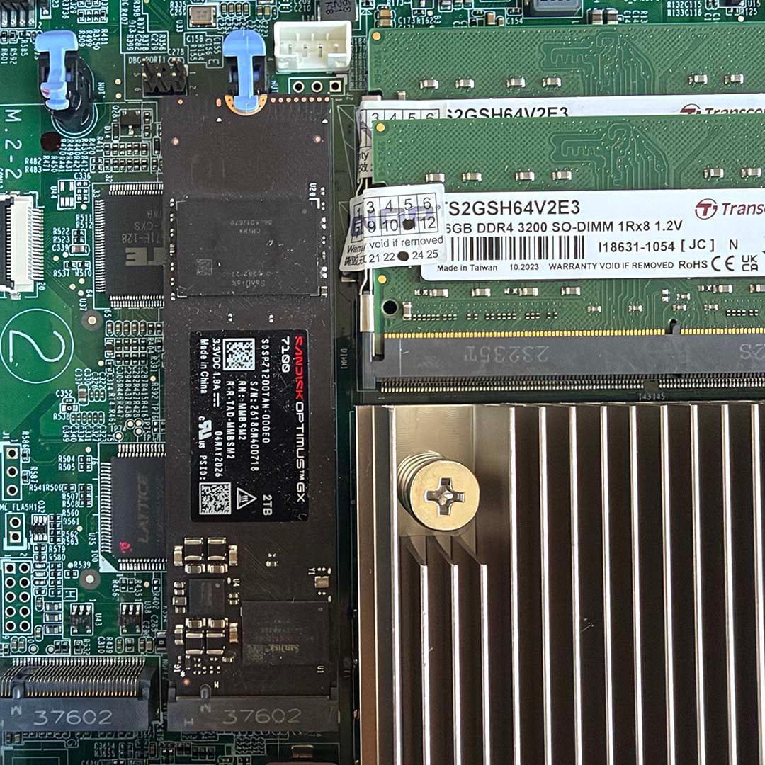 QNAP TVS-hx74T NAS showing DDR4 RAM and a SanDisk Optimus GX 7100 SSD installed